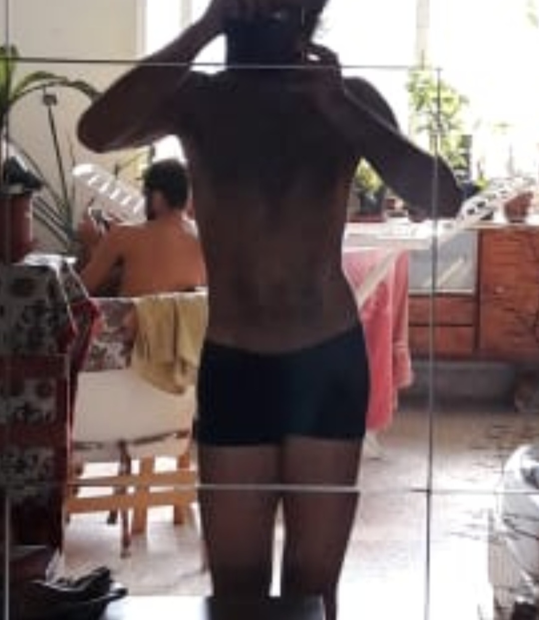 Client before starting training, showing lower-back scoliosis and visible imbalance through the torso.