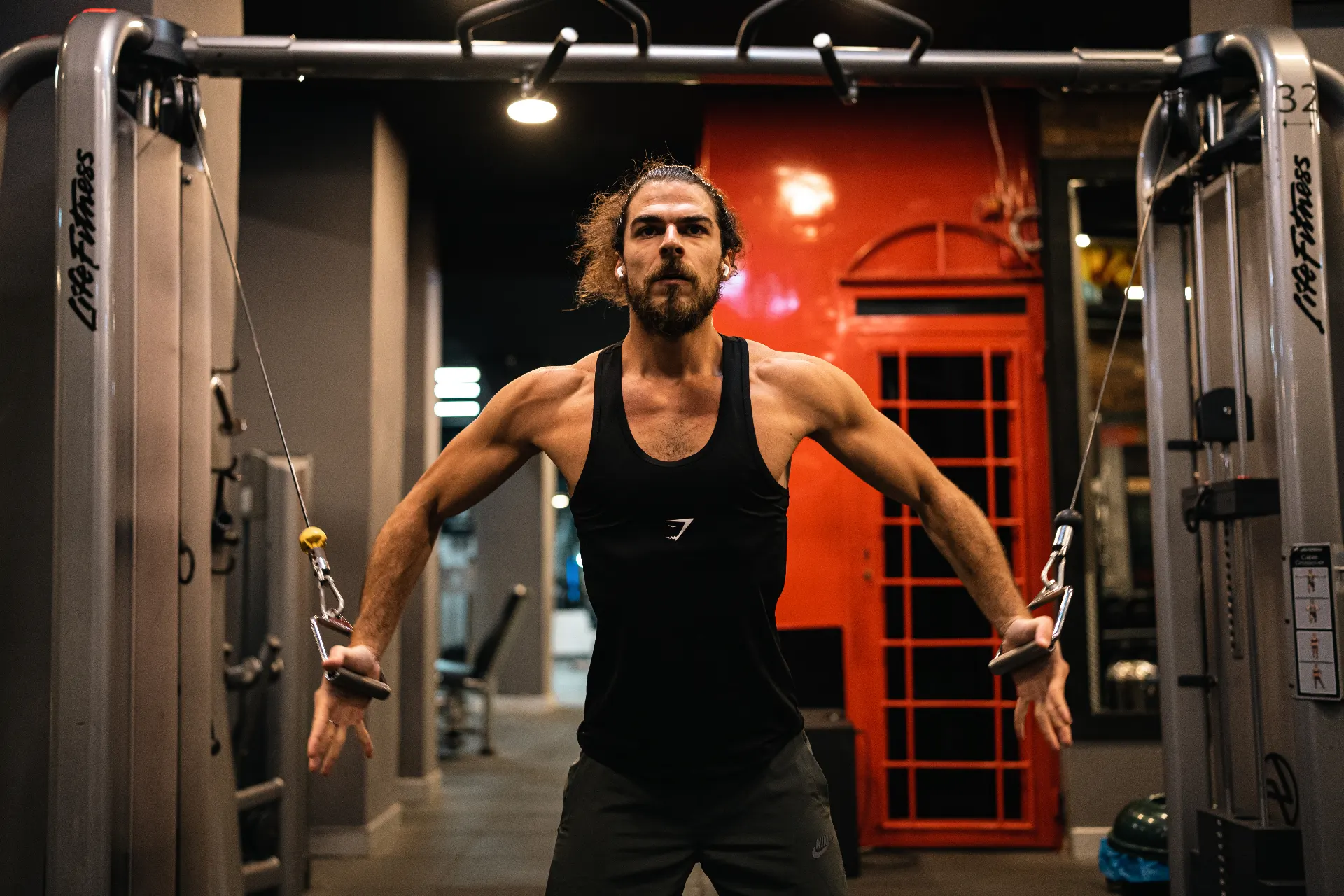 Samer performing a cable fly in the gym